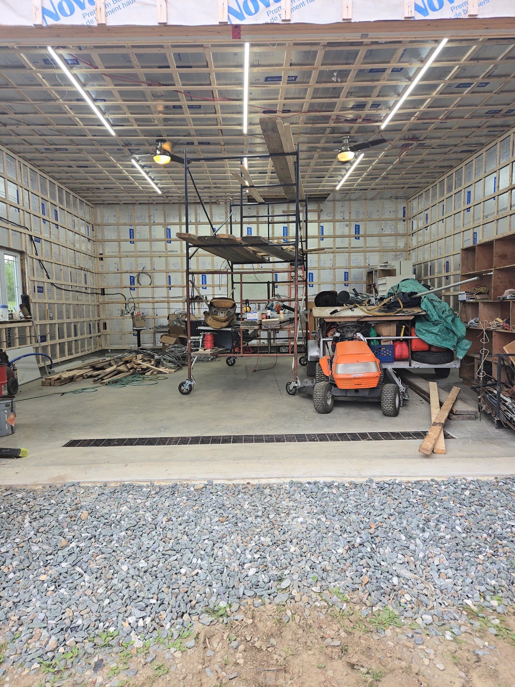 Large garage under construction, LED tubes already installed on the ceiling