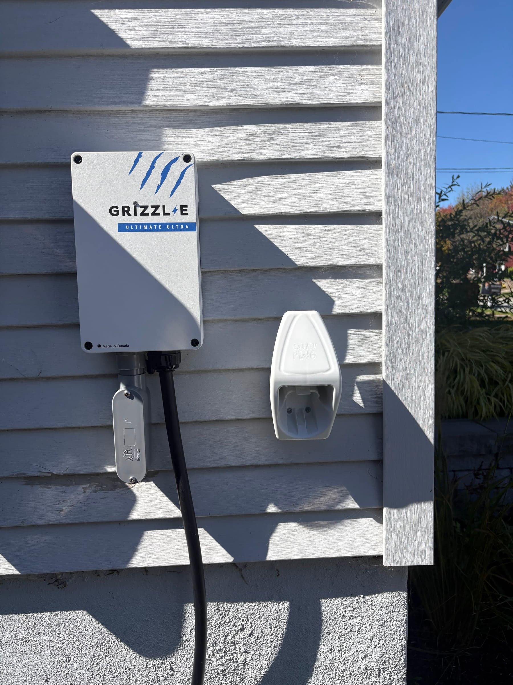 Grizzl-E level 2 charger installed on the siding of a house