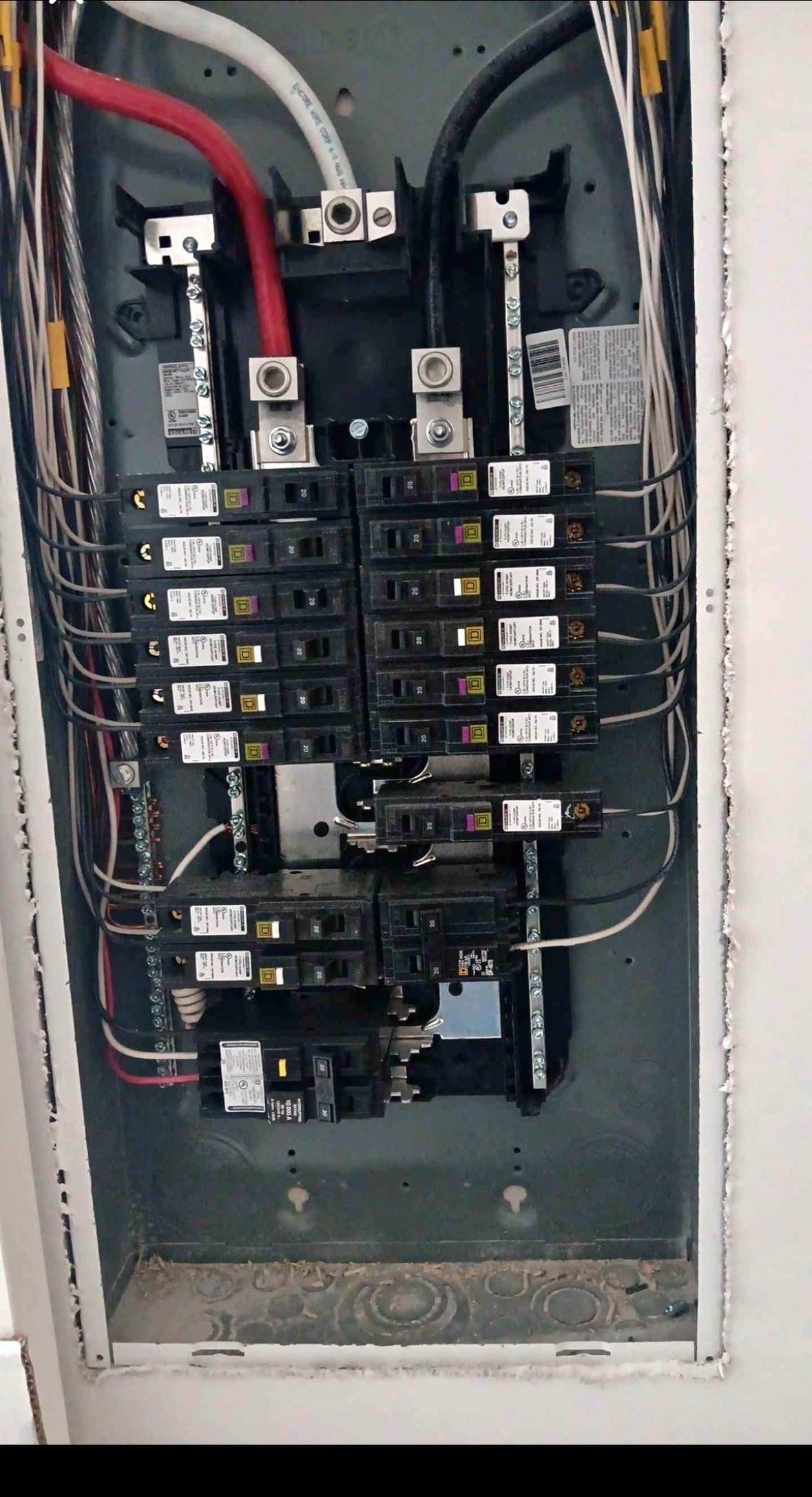 Open electrical panel with aligned breakers and neatly routed wires